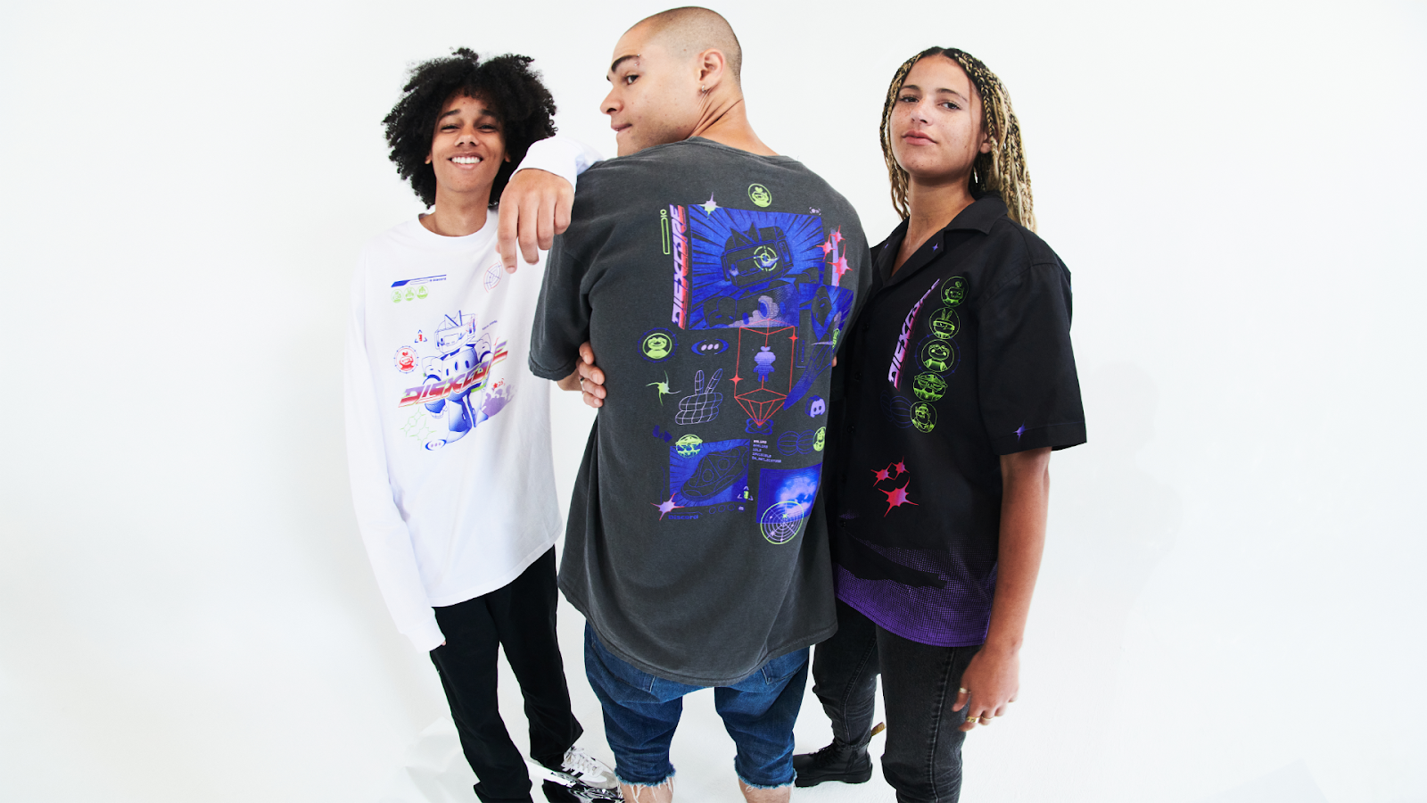 Three friends wearing the DISXCORE long-sleeve tee, DISXCORE short-sleeve tee, and the DISXCORE women’s cut tee.
