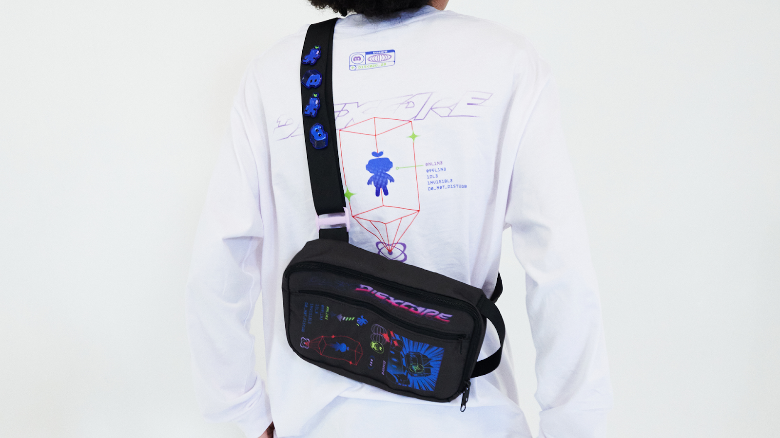 Someone using the DISXCORE Sling Bag. They have DISXCORE pins on the bag’s strap.
