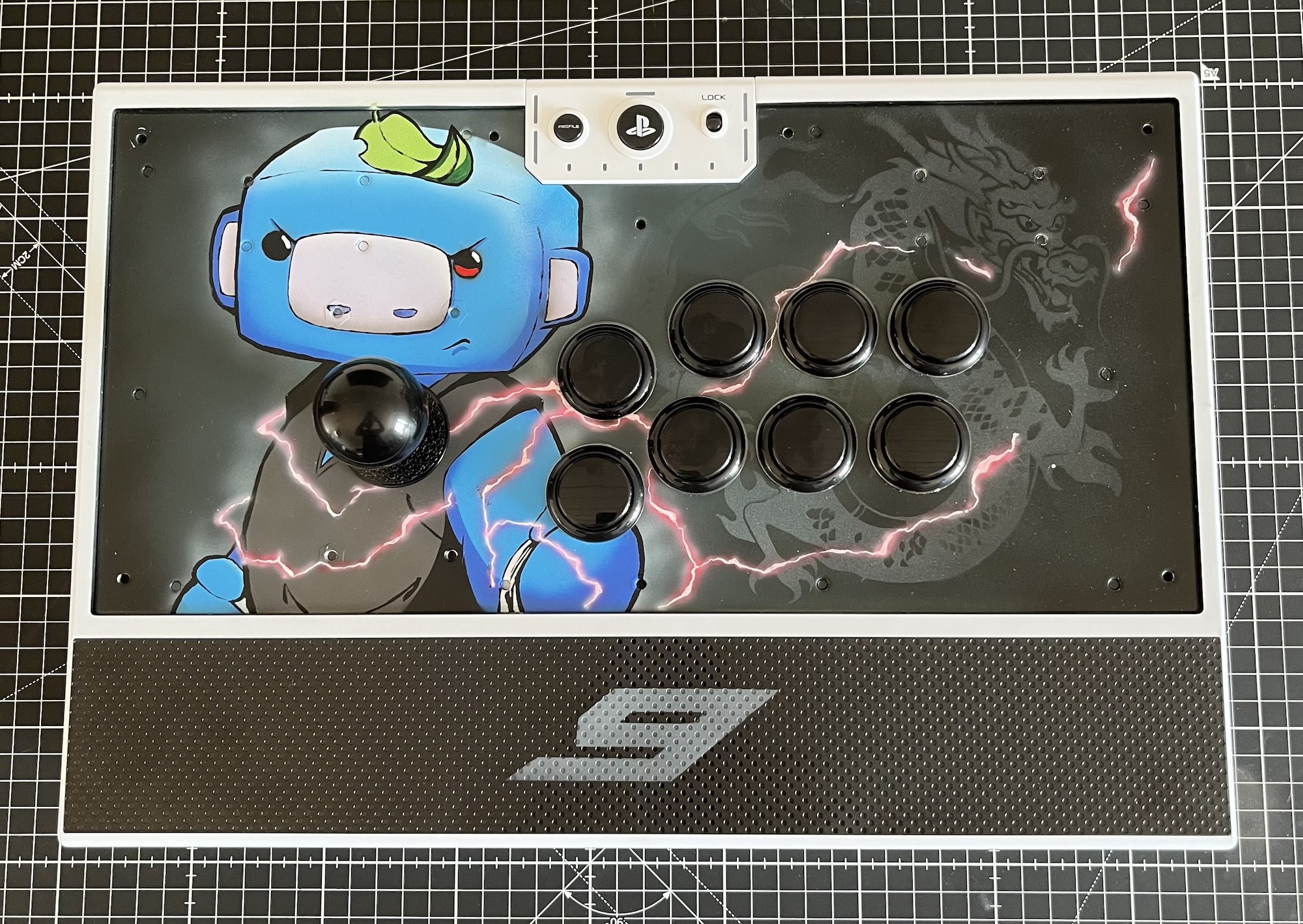 An arcade stick with an illustration of Wumpus in a fighting stance wearing karate gear